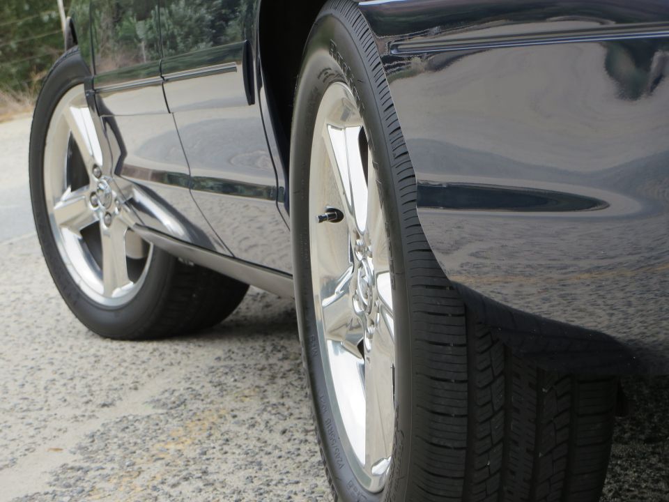 Black 2003 Mercury Marauder side view showing chrome wheels and lower body trim