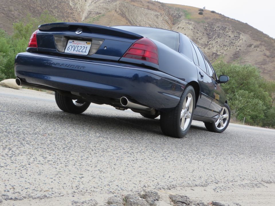 Blue 2003 Mercury Marauder sedan, rear 3/4 view, on a paved road
