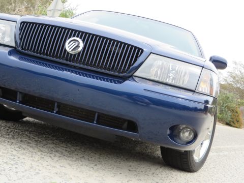 2003 Mercury Marauder - Front view of a blue 2003 Mercury Marauder, highlighting its distinctive grille and headlights.