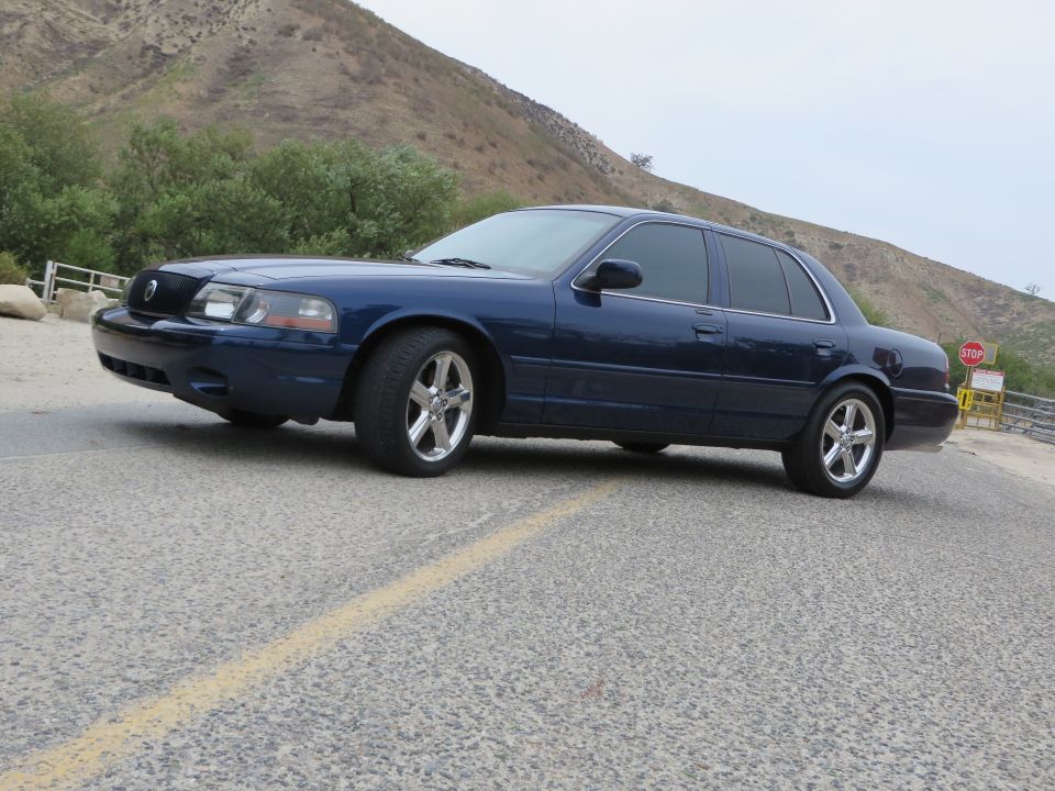2003 Mercury Marauder parked on a road with a hill in the background