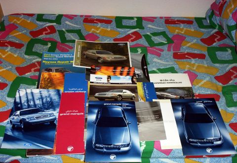 1999 Mercury Grand Marquis - Various brochures and repair manuals for Mercury Grand Marquis and Ford Crown Victoria models are displayed.