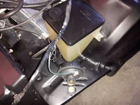 1976 Ford Ranchero - Close-up view of the windshield washer fluid reservoir and horn assembly, likely from a 1970s vehicle.