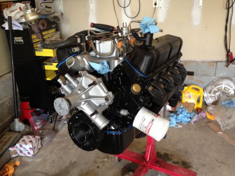 1994 Ford Bronco - Engine assembly on a stand, likely for a Ford vehicle. Oil filter and various tools are visible.