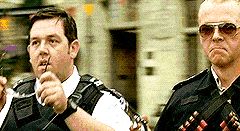 2000 Mercury Grand Marquis - Two police officers are shown in this scene, one appears to be adjusting his glasses.