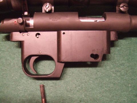 1996 Ford Bronco - Close-up of a rifle receiver and trigger assembly, with a bolt and scope mount.