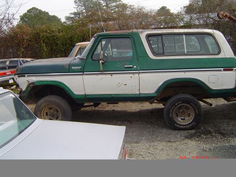 1978 Ford Bronco - This 1978 Ford Bronco is shown in a side profile, parked in an outdoor lot with other vehicles.