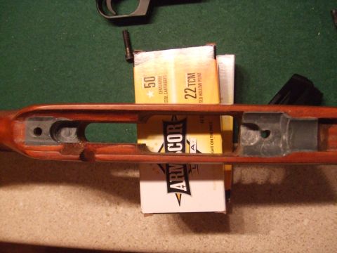 1996 Ford Bronco - A wooden gun stock is shown with two boxes of ammunition, one labeled 22 TCM and the other 50 caliber cartridges.