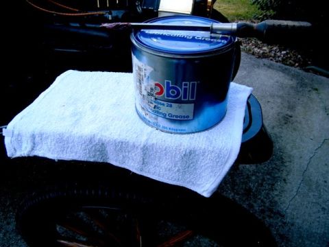 1915 Ford Model T - A can of Mobil lubricating grease rests on a towel, which is placed on a tire.