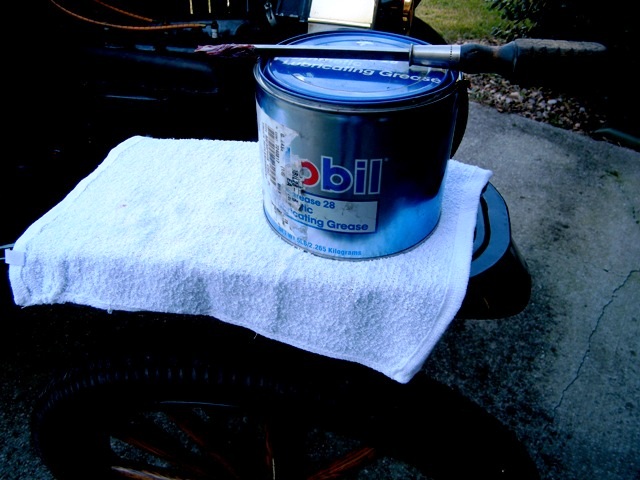 Can of Mobil lubricating grease on a white towel placed on a tire