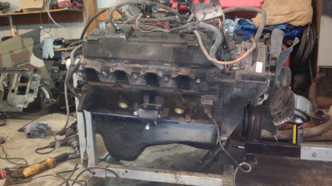 1995 Ford Bronco - Engine assembly on a stand in a workshop setting.