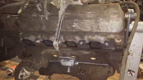 1995 Ford Bronco - This is a close-up view of an engine block, showing the spark plug holes and exhaust manifolds.