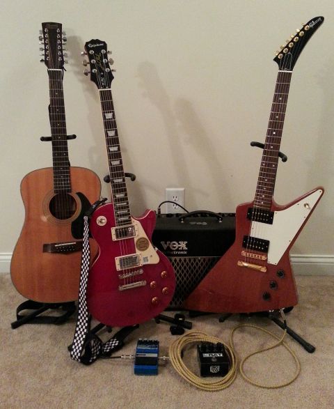 2003 Ford Crown Victoria - A collection of guitars and an amplifier are arranged on the floor.