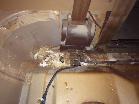 1991 Ford Bronco - Significant rust damage is visible on the interior floor pan, with exposed wiring present.