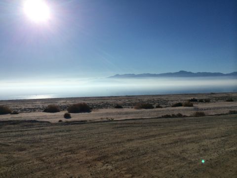 1986 Yugo GV - A hazy desert scene with the sun shining brightly in the sky.