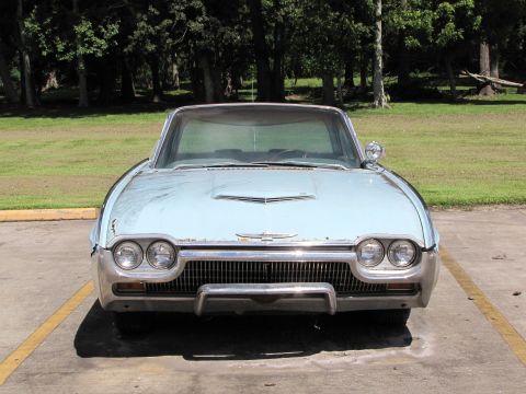 1963 Ford Thunderbird - This 1963 Ford Thunderbird is parked outdoors, showing its distinctive front grille and headlights.