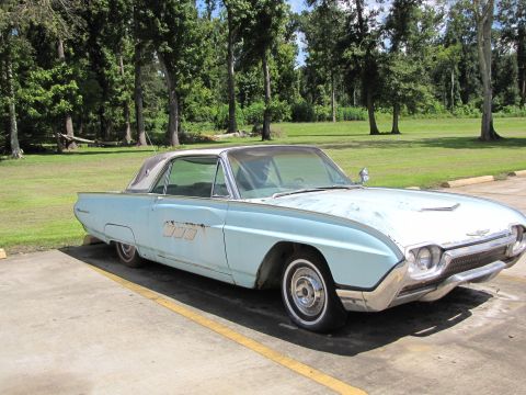 1963 Ford Thunderbird - A light blue 1963 Ford Thunderbird coupe is parked outdoors, showing its distinctive body style and some signs of age.