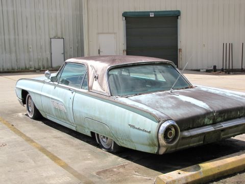 1963 Ford Thunderbird - This car has a faded paint job and appears to be in need of restoration.