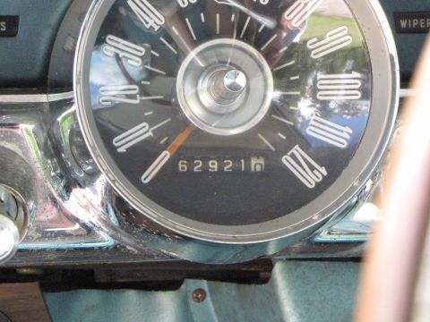 1963 Ford Thunderbird - Close-up of a car's interior dashboard, focusing on the speedometer and odometer.