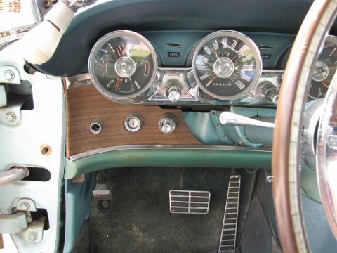 1963 Ford Thunderbird - The distinctive interior of a 1963 Ford Thunderbird, its iconic dashboard layout with dual gauges and wood grain accents.