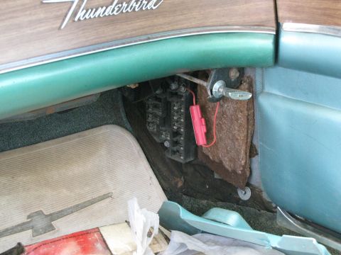 1963 Ford Thunderbird - The interior of a 1963 Ford Thunderbird reveals its distinctive dashboard trim and a floor mat bearing the model's iconic bird emblem.