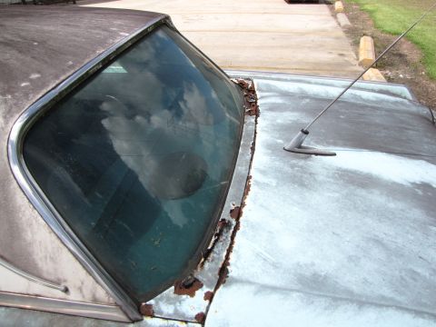 1963 Ford Thunderbird - Close-up of a 1963 Ford Thunderbird showing rust around the windshield and hood.
