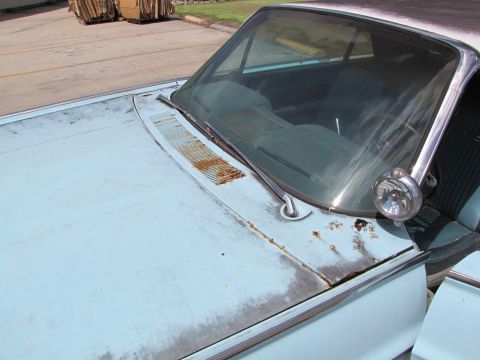 1963 Ford Thunderbird - This vehicle shows signs of age with rust on the hood and around the windshield trim.