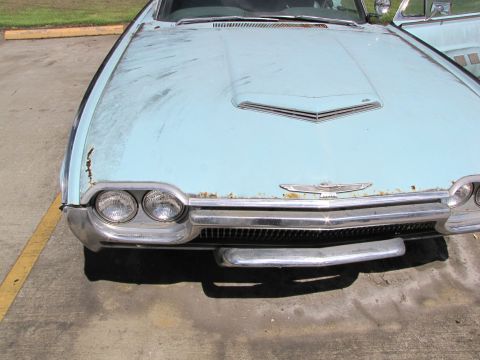1963 Ford Thunderbird - The front of a light blue 1963 Ford Thunderbird shows its distinctive grille and dual headlights.