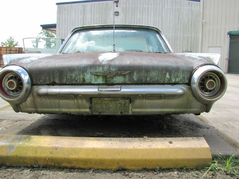 1963 Ford Thunderbird - This 1963 Ford Thunderbird shows significant wear and tear, with rust and grime covering its iconic body.