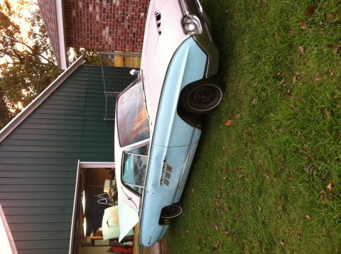 1963 Ford Thunderbird - 1963 Ford Thunderbird in a light blue and white two-tone paint scheme, seen from a 3/4 front angle.