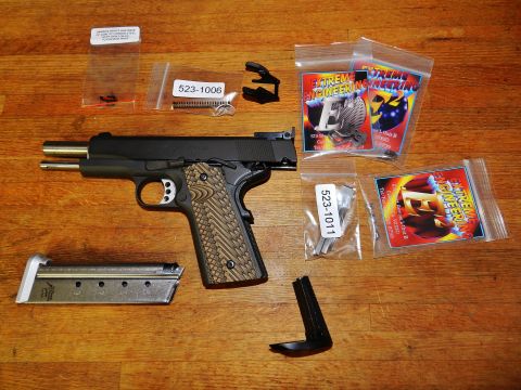 1996 Ford Bronco - Pistol and associated parts are displayed on a wooden table. Packaging from 'Extreme Engineering' is present.