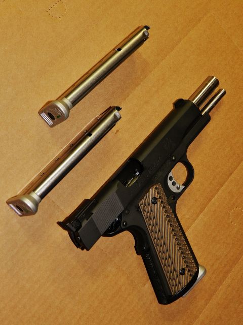 1996 Ford Bronco - A Springfield RO 1911 9mm pistol is shown with two spare magazines laid out on a brown background.