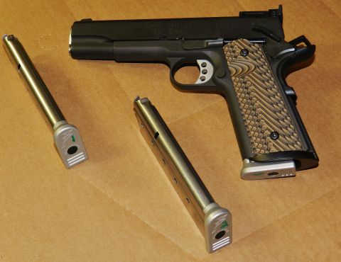 1996 Ford Bronco - A black pistol with two magazines is displayed on a brown surface.