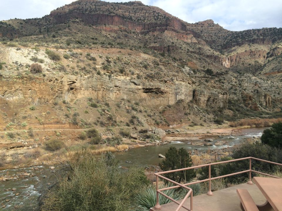 Mountainous terrain with a river flowing through a canyon, viewed from a picnic area
