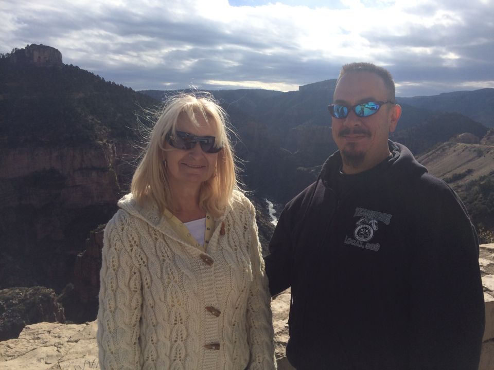 Couple posing for a photo with a canyon landscape in the background