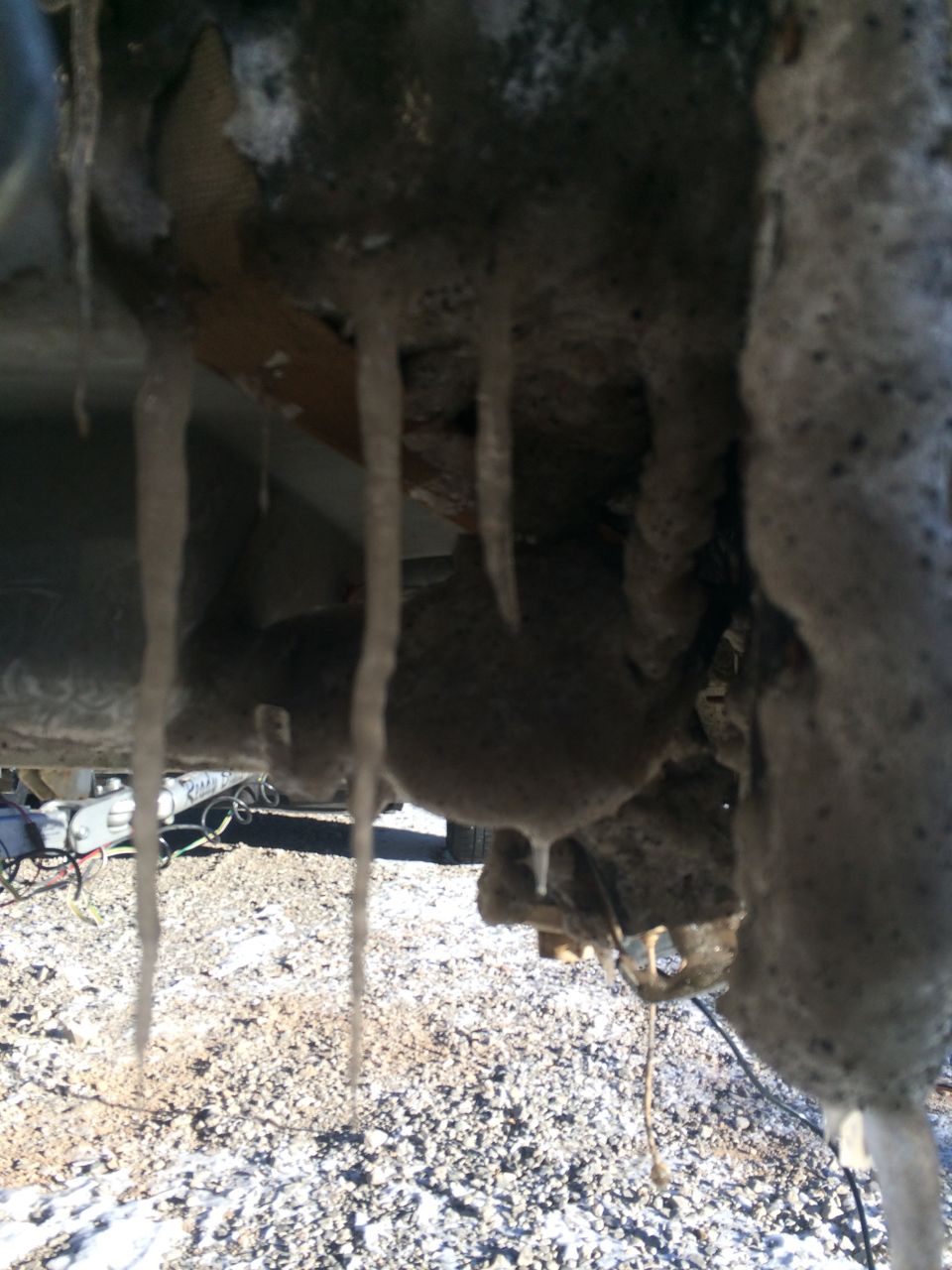 Underbody of a vehicle with icicles hanging from it