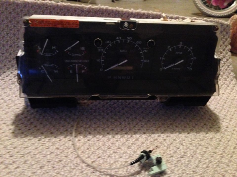 Vehicle instrument cluster with speedometer, tachometer, fuel gauge, and temperature gauge