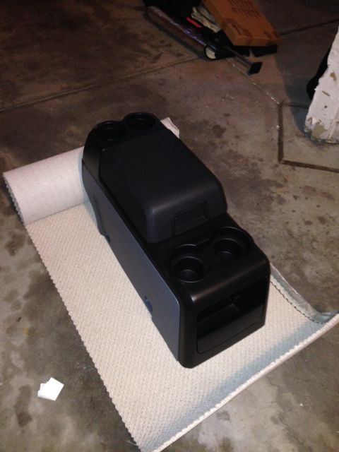 1995 Ford Bronco - Center console with cup holders and storage compartment, likely from a Ford vehicle.