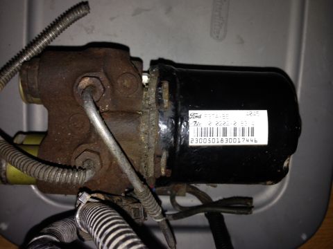 1995 Ford Bronco - A close-up of a Ford brake booster, showing its part number and some rust.