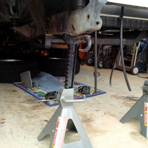 1978 Ford Bronco - Vehicle frame is elevated on jack stands for maintenance or repair work.