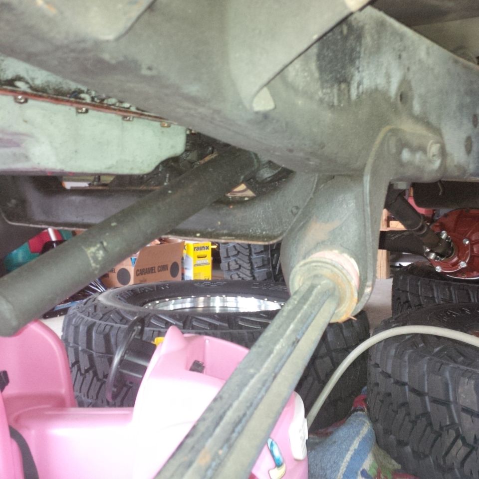 Undercarriage view of vehicle suspension components and tires