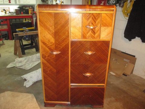 2004 Aston Martin Virage - An Art Deco dresser with intricate wood detailing and brass hardware sits in a cluttered garage.