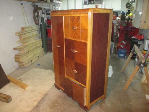 2004 Aston Martin Virage - An art deco wardrobe with intricate wood inlay and brass handles is pictured in a garage setting.