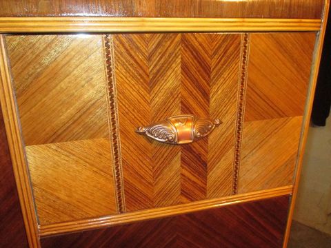 2004 Aston Martin Virage - Close-up of a vintage furniture drawer detailed wood grain patterns and a unique handle.