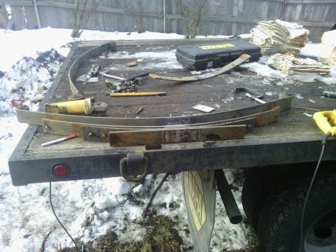 1995 GMC Safari - Tools and vehicle parts are laid out on a trailer, suggesting repair or modification work is underway.