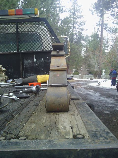 1995 GMC Safari - A leaf spring is shown on a flatbed truck, with various tools scattered around.