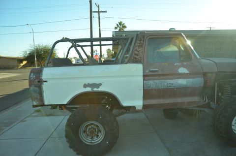 1979 Ford Bronco - This Ford Bronco is in a state of repair, with one side primed and the other showing rust.