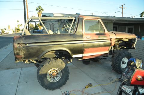 1979 Ford Bronco - This modified Ford Bronco is undergoing work, with a roll cage installed and the front end removed.