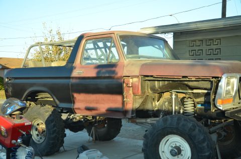 1979 Ford Bronco - This 1979 Ford Bronco appears to be in the process of a significant modification, a prominent roll cage and custom suspension.