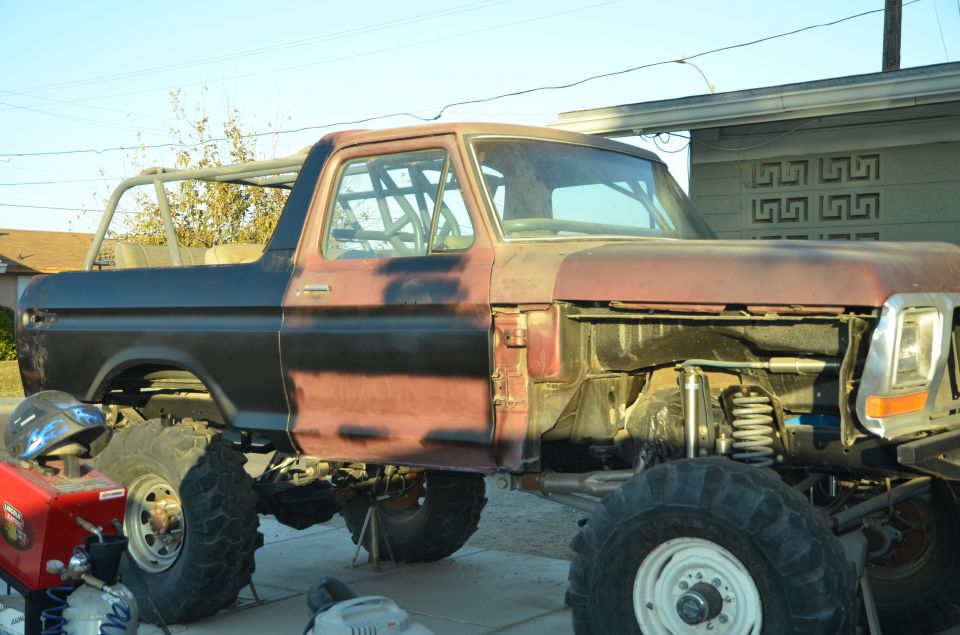 1979 Ford Bronco with roll cage, undergoing modifications