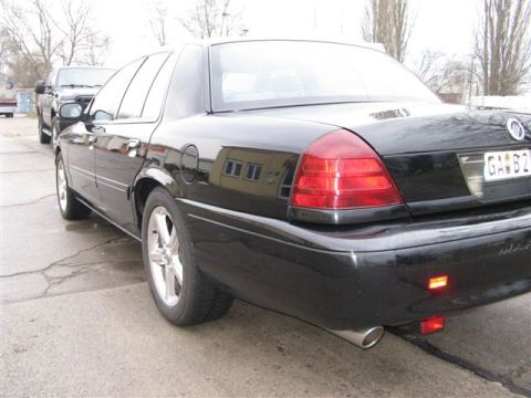 2003 Mercury Marauder - Rear view of a black 2003 Mercury Marauder sedan parked next to another vehicle.